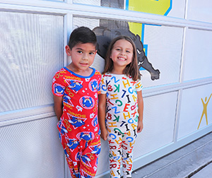A little boy and girl in their PJs for PJammin Day 2022